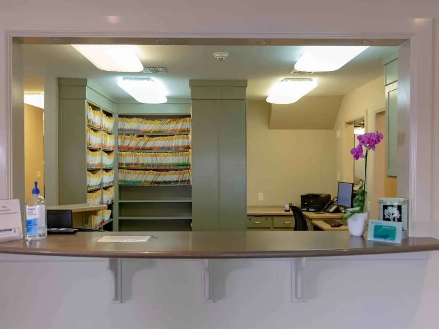 The check-in window and patient records at Bayou Dental.