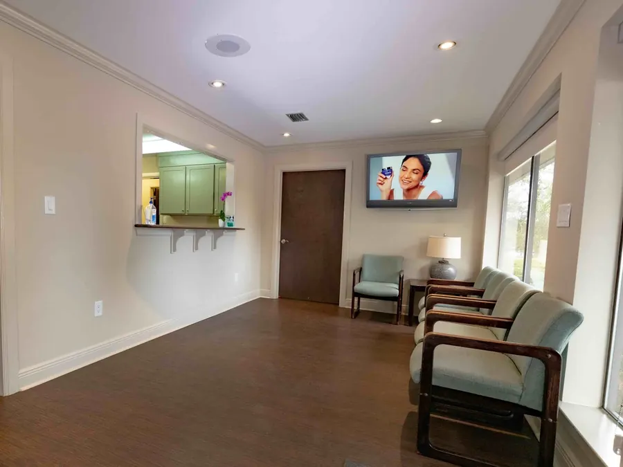 The Bayou Dental waiting room, with the check-in window beyond.